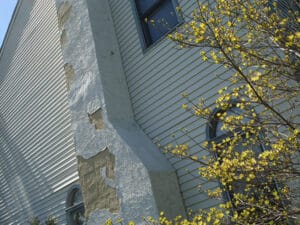 stucco falling off house